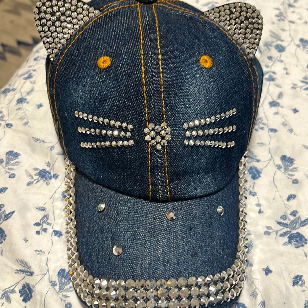 Denim women’s kitty hat. Brand new, never worn. Missing one rhinestone.